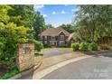 Charming exterior view showcases a meticulously landscaped front yard and a brick mailbox near the entrance at 3916 2Nd Street Nw Dr, Hickory, NC 28601