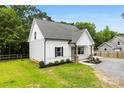 This home boasts light siding, a gray roof, and well-maintained landscaping, exuding modern curb appeal at 529 N Central Ave, Locust, NC 28097