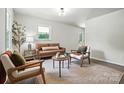 Bright living room with neutral tones, modern furniture, and ample natural light at 617 Rock Hill Church Rd, Matthews, NC 28104