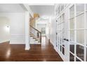 Open foyer with hardwood flooring, decorative wainscotting and French doors leading to the front office at 646 Quicksilver Trl # 183, Fort Mill, SC 29708