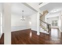 Expansive living room featuring hardwood floors, decorative wainscotting and an elegant staircase at 646 Quicksilver Trl # 183, Fort Mill, SC 29708