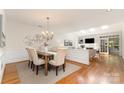 Elegant dining room with a chandelier, hardwood floors, and open layout at 6602 Gaywind Dr, Charlotte, NC 28226