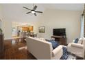 Open-concept living room with hardwood floors, vaulted ceilings, and an adjacent modern kitchen at 703 Dalebrook Ln, Rock Hill, SC 29730