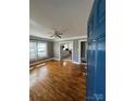Inviting living room featuring gleaming hardwood floors, neutral paint, and an open doorway to the kitchen at 706 13Th Sw St, Hickory, NC 28602