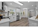 Modern kitchen with white cabinets, stainless steel appliances, granite counters, and bright lighting at 7219 Spring Morning Ln, Charlotte, NC 28227