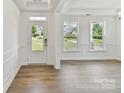Bright entryway featuring wood floors, white trim, and a view of the outdoors at 7717 Nautical View Dr, Denver, NC 28037