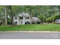 Charming two-story home featuring a lush green lawn and a classic colonial design with black shutters at 9424 Whitethorn Dr, Charlotte, NC 28277
