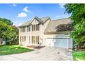 Charming two-story home featuring a well-manicured lawn, driveway, and attached two-car garage at 953 Milkwood Ln, Monroe, NC 28110