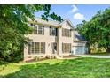 Charming two-story home with a well-manicured lawn, black shutters, and a two-car garage at 953 Milkwood Ln, Monroe, NC 28110