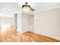 Bright living room showcasing hardwood floors, a stylish chandelier, and neutral paint tones at 953 Milkwood Ln, Monroe, NC 28110
