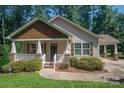 Beautiful home showcasing a charming covered porch and well-maintained shrubbery at 110 Leeper Ave, Belmont, NC 28012
