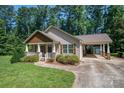 Attractive single-Gathering home with front porch, connected carport, and well-kept yard surrounded by tall trees at 110 Leeper Ave, Belmont, NC 28012