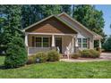 Inviting home featuring a cozy covered porch with white railings and neatly trimmed landscaping at 110 Leeper Ave, Belmont, NC 28012