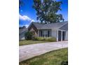 View of single-story home with a long driveway and fenced area and mature trees at 1114 Cason St # 6, Belmont, NC 28012