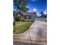 Single-story home with a long driveway, fenced area, and well-maintained lawn and landscaping at 1114 Cason St # 6, Belmont, NC 28012