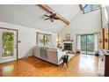 Bright living room features vaulted ceilings, wood floors, fireplace, and sliding glass doors to outdoor space at 1119 Palmyra Dr, Fort Mill, SC 29708
