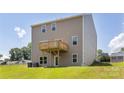 Exterior showcasing a spacious backyard with a wooden deck and green lawn at 119 Rustling Waters Dr, Mooresville, NC 28117