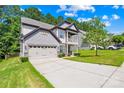 Charming two-story home with a two car garage, a front porch, and a well-manicured lawn at 120 Carolinian Dr, Statesville, NC 28677