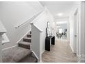 Bright entryway with wood floors, stairway, console table, and modern mirror decor at 12548 Gotland Rd # 327, Midland, NC 28107