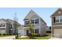 Exterior of a two-story home with light siding, attached garage, and lovely curb appeal on a sunny day at 12548 Gotland Rd # 327, Midland, NC 28107