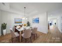 The dining area features hardwood floors, wainscoting and contemporary decor at 15120 Cavanshire Trl, Charlotte, NC 28278