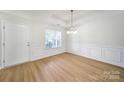 Bright dining area with tray ceiling, hardwood floors, wainscoting and lots of natural light at 15120 Cavanshire Trl, Charlotte, NC 28278