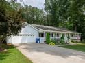 Home with attached garage, long driveway, front porch, and manicured landscaping at 170 Eagle Dr, Salisbury, NC 28144