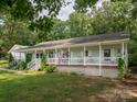 Traditional home featuring a full-length front porch and manicured landscaping at 170 Eagle Dr, Salisbury, NC 28144