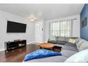 Comfortable living room with a large sectional sofa, hardwood floors and natural light at 2726 Tranquil Oak Pl, Charlotte, NC 28206