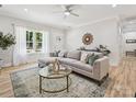 Bright living room with natural light, plush sofa, stylish rug, glass top table, and modern decor at 286 Old Pinckney Rd, York, SC 29745