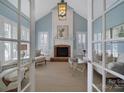 Elegant living room with a fireplace, shuttered windows, and tasteful decor at 2909 Julian Glen Cir, Waxhaw, NC 28173