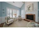 Bright living room featuring a fireplace, natural light and comfortable seating at 2909 Julian Glen Cir, Waxhaw, NC 28173