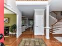 Welcoming foyer features hardwood floors and staircase, creating an inviting entrance at 3401 Cresta Ct, Charlotte, NC 28269
