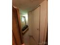 Hallway view featuring a neutral color scheme and closet at 3913 Stough Sw Rd, Concord, NC 28027