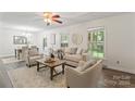 Bright living room with neutral decor, large windows, and a view of the dining area at 3943 Peggy Ln, Mint Hill, NC 28227