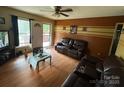 Living room featuring hardwood floors, access to the back porch, and a comfortable couch at 407 Alton St, Monroe, NC 28110