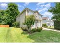 A two-story home boasts a well-maintained lawn and minimal landscaping for a tidy appearance at 4462 Kellybrook Dr, Concord, NC 28025