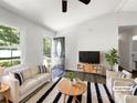 Bright living room with modern furniture, including a sofa, armchairs, and stylish black-and-white rug at 4903 Jamee Dr, Gastonia, NC 28056