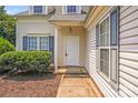 Inviting front entrance featuring a white door, neat landscaping, and neutral siding enhancing the curb appeal at 5417 Timbertop Ln, Charlotte, NC 28215