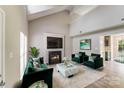 Chic living room with vaulted ceilings, a sleek fireplace, and stylish green accents create a sophisticated space at 5417 Timbertop Ln, Charlotte, NC 28215