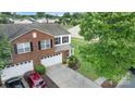 Aerial view of a two-story home with a well-manicured lawn, two-car garage, and landscaped front yard at 6340 Ziegler Ln # 148-A, Charlotte, NC 28269