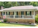 Inviting front porch with white railing, perfect for relaxing and enjoying the outdoors at 6601 Charlotte Hwy, York, SC 29745