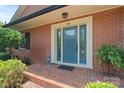 Close up of a lovely brick porch and a charming blue front door with sidelights at 747 9Th Nw St, Hickory, NC 28601