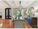 Formal dining room boasts hardwood floors, a stylish light fixture, and sophisticated decor at 9000 Whirlaway Ln, Waxhaw, NC 28173