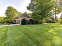 Beautiful home with manicured lawn and landscaping in a tranquil setting, showcasing impeccable curb appeal at 9000 Whirlaway Ln, Waxhaw, NC 28173