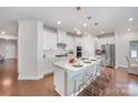 Modern kitchen featuring a central island with bar seating and elegant pendant lights at 9311 Dunwich Dr, Gastonia, NC 28056
