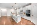 Stylish kitchen featuring a spacious island with bar stools and sleek stainless steel appliances at 9311 Dunwich Dr, Gastonia, NC 28056