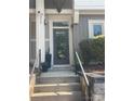 View of a home's front door with address number and well-manicured landscaping at 1013 Park West Dr # 5, Charlotte, NC 28209