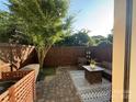 Private outdoor patio with stylish furnishings, brick pavers, and wood fence at 1013 Park West Dr # 5, Charlotte, NC 28209