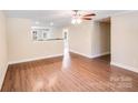 Open-concept living area with modern flooring, ceiling fan, neutral walls and easy access to the kitchen at 115 Dove Sw Ave, Concord, NC 28025